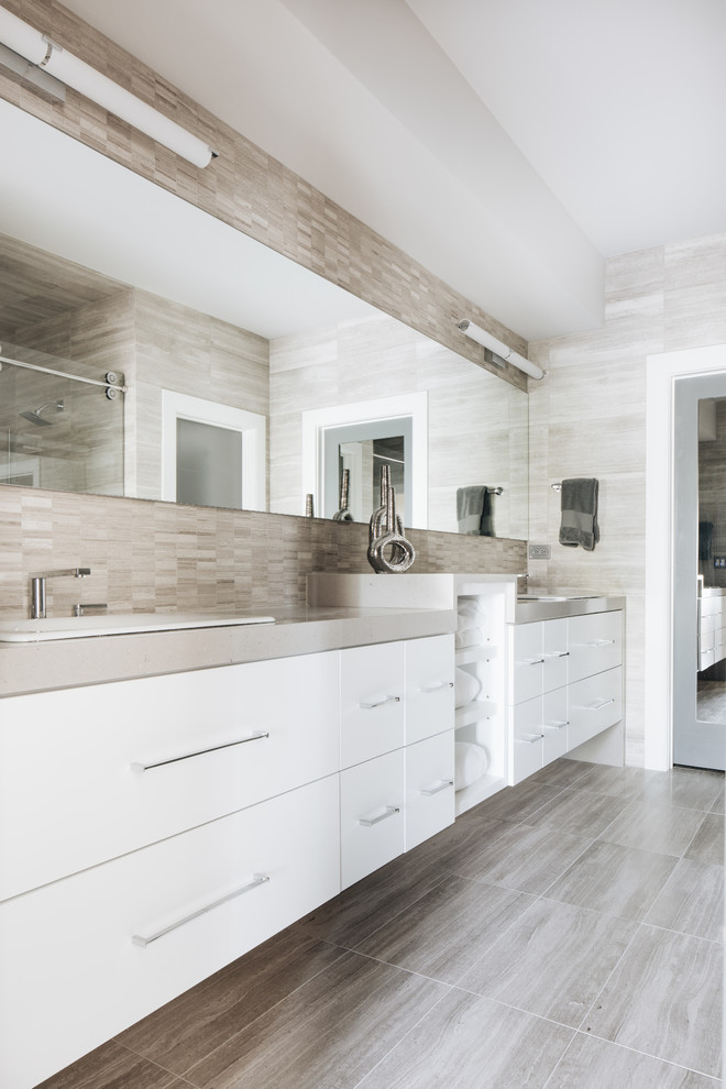 This is an example of a medium sized contemporary ensuite bathroom in Chicago with flat-panel cabinets, white cabinets, an alcove shower, a one-piece toilet, beige tiles, travertine tiles, grey walls, travertine flooring, a built-in sink, engineered stone worktops, beige floors, a sliding door and white worktops.