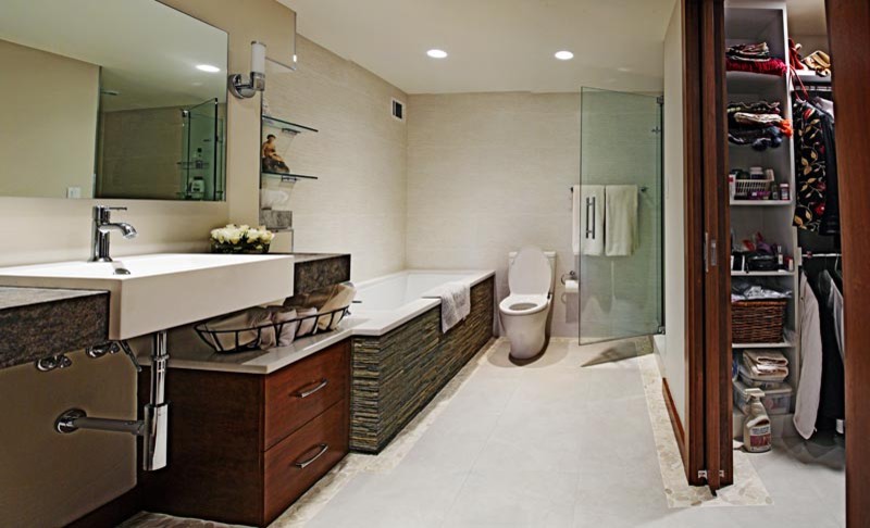 Design ideas for a medium sized contemporary ensuite bathroom in DC Metro with flat-panel cabinets, medium wood cabinets, a submerged bath, an alcove shower, a one-piece toilet, beige tiles, ceramic tiles, beige walls, ceramic flooring, a wall-mounted sink and concrete worktops.