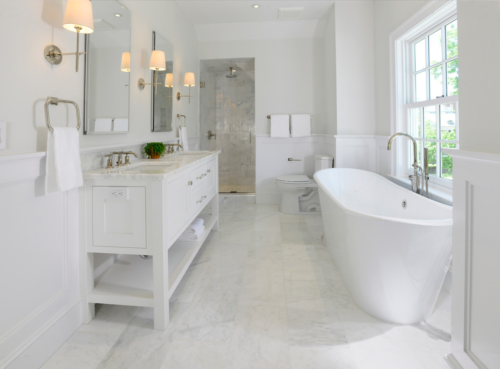 Example of a large country master white tile and stone tile marble floor bathroom design in New York with shaker cabinets, white cabinets, a one-piece toilet, white walls, a drop-in sink and marble countertops