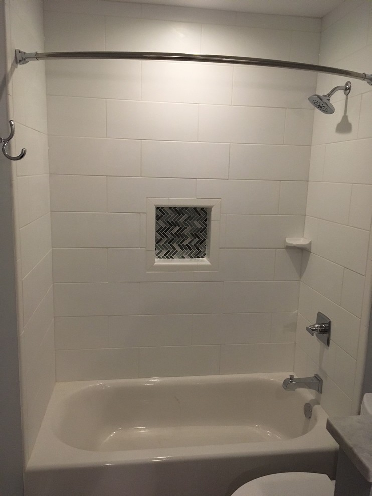 Inspiration for a medium sized contemporary bathroom in Indianapolis with flat-panel cabinets, white cabinets, an alcove bath, an alcove shower, a two-piece toilet, grey walls, mosaic tile flooring, a submerged sink, granite worktops, grey floors, a shower curtain, grey tiles and mosaic tiles.