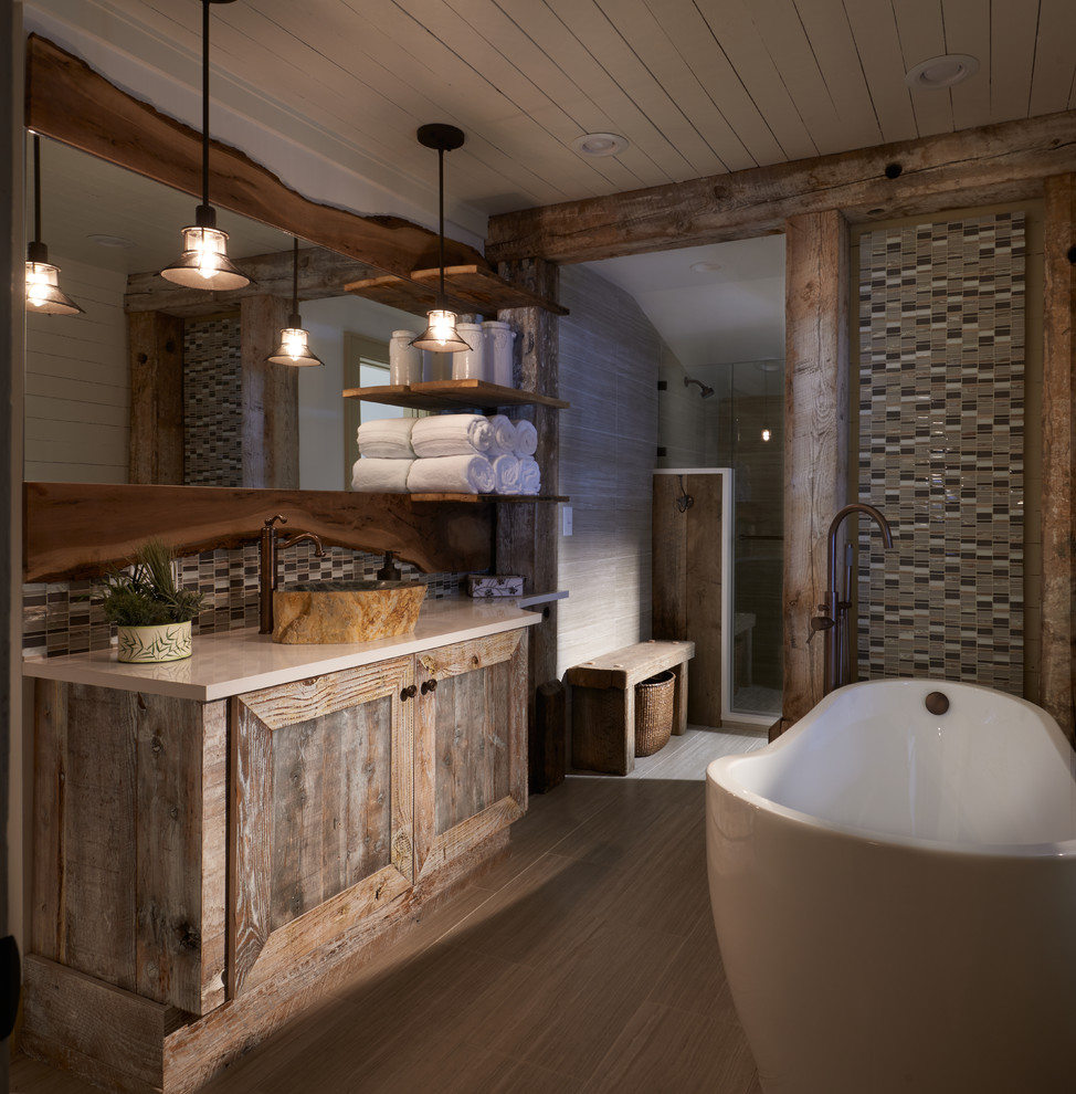 Large mountain style master multicolored tile and glass tile porcelain tile, gray floor, single-sink and shiplap ceiling bathroom photo in Other with recessed-panel cabinets, distressed cabinets, beige walls, a vessel sink, quartz countertops, a one-piece toilet and a built-in vanity
