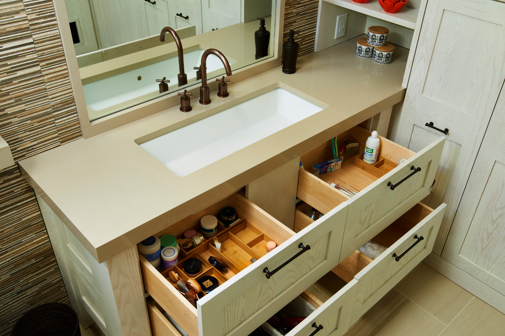 Photo of a medium sized ensuite bathroom in Other with recessed-panel cabinets, beige cabinets, a corner shower, a one-piece toilet, multi-coloured tiles, ceramic tiles, white walls, ceramic flooring, a submerged sink, beige floors, a hinged door, a single sink, a built in vanity unit, a vaulted ceiling and tongue and groove walls.
