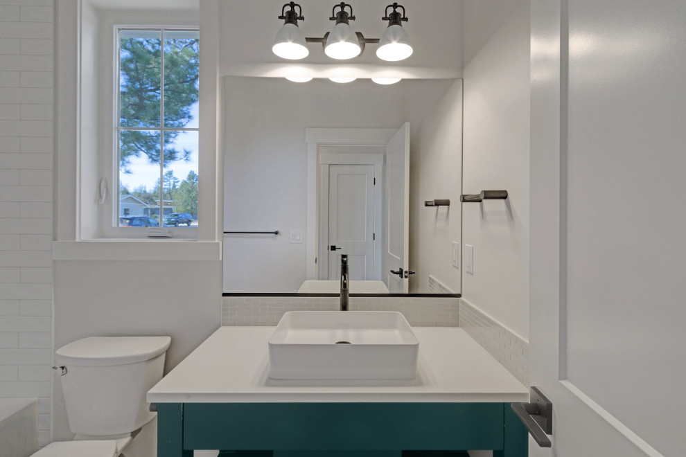Inspiration for a large cottage 3/4 white tile and ceramic tile single-sink bathroom remodel in Portland with green cabinets, a two-piece toilet, white walls, a vessel sink, quartz countertops and white countertops