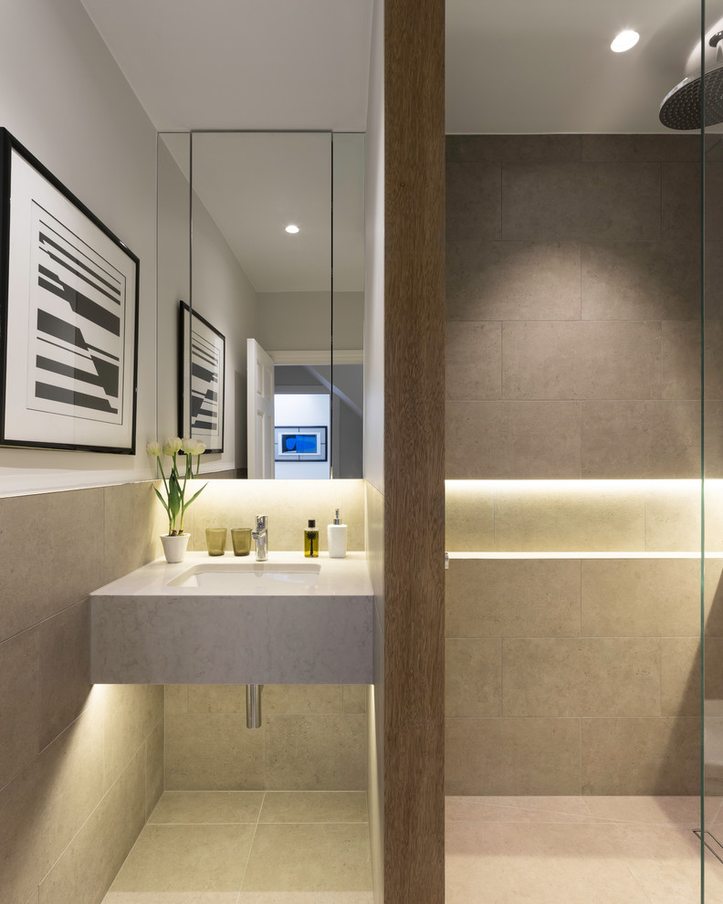 Small contemporary shower room bathroom in London with flat-panel cabinets, beige cabinets, a walk-in shower, a wall mounted toilet, beige tiles, porcelain tiles, beige walls, porcelain flooring, an integrated sink, engineered stone worktops, beige floors and an open shower.