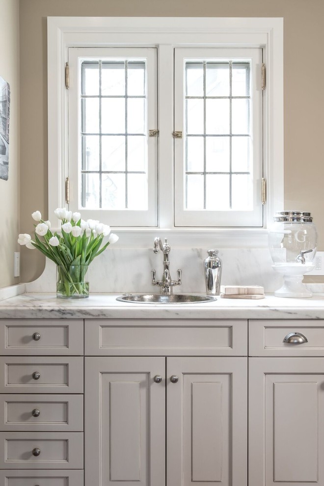 Example of a mid-sized minimalist 3/4 bathroom design in Other with raised-panel cabinets, gray cabinets, a drop-in sink and marble countertops