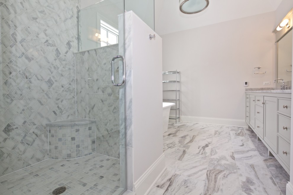 This is an example of a medium sized coastal ensuite bathroom in Chicago with recessed-panel cabinets, grey cabinets, a freestanding bath, a corner shower, white tiles, stone slabs, white walls, mosaic tile flooring, an integrated sink and marble worktops.