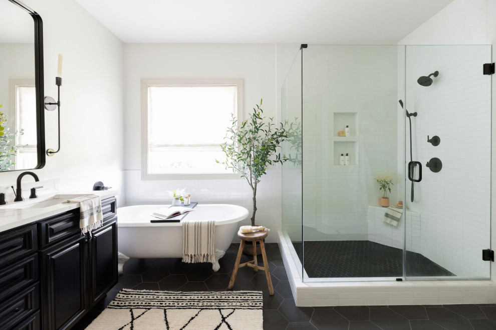 Bathroom - transitional master white tile and ceramic tile black floor and double-sink bathroom idea in Nashville with black cabinets, white walls, an undermount sink, quartz countertops, a hinged shower door, white countertops, a niche, a built-in vanity and raised-panel cabinets