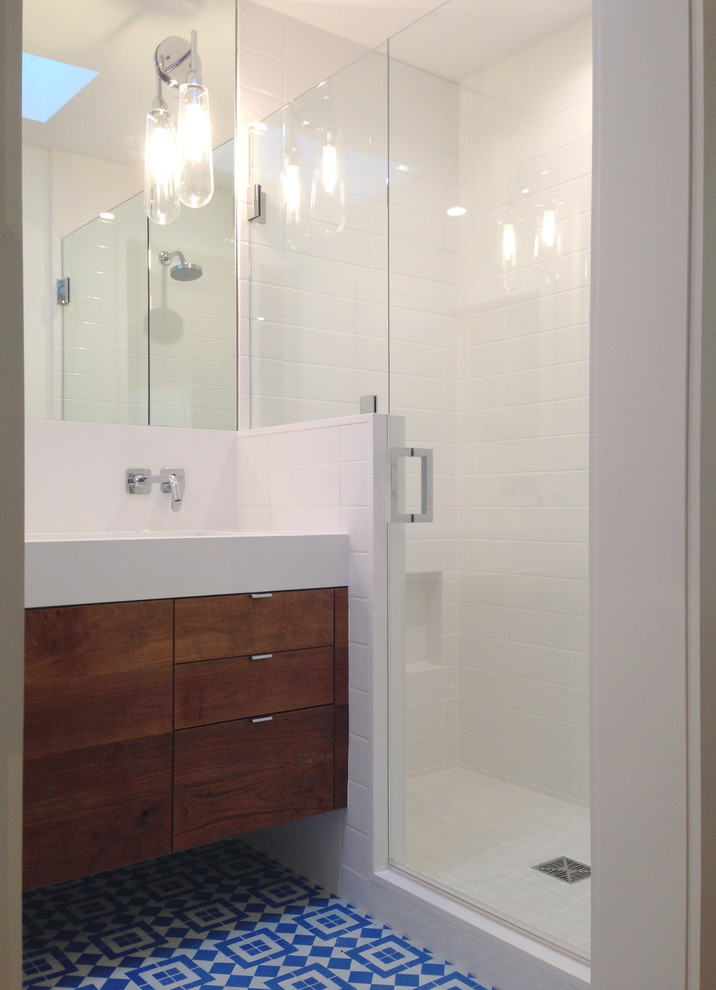 Photo of a contemporary shower room bathroom in Tampa with an integrated sink, granite worktops, cement tiles, dark wood cabinets, white walls, blue tiles and white tiles.