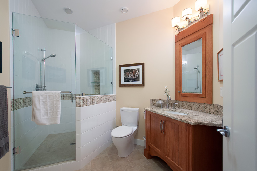 This is an example of a contemporary bathroom in Vancouver with a submerged sink, shaker cabinets, medium wood cabinets, granite worktops, an alcove bath, a corner shower, a two-piece toilet, brown tiles and mosaic tiles.