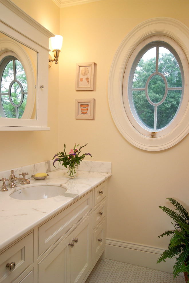 Classic bathroom in Boston with a built-in sink, beige cabinets, marble worktops, beige tiles and mosaic tiles.