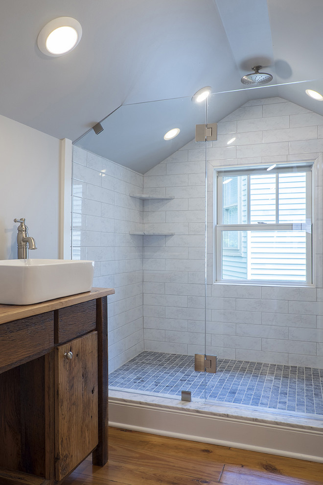 This is an example of a large traditional shower room bathroom in Louisville with white tiles, ceramic tiles, grey walls and medium hardwood flooring.