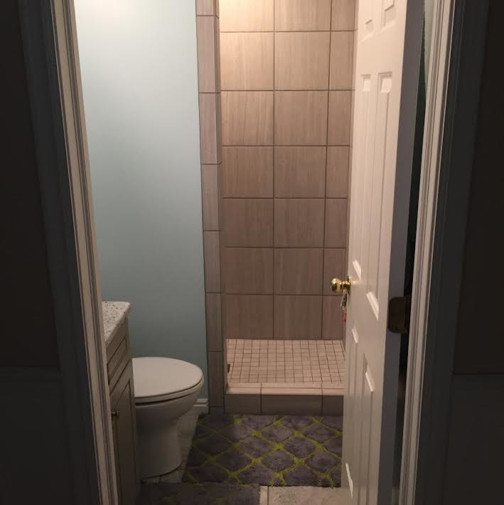Klassisk inredning av ett litet badrum med dusch, med luckor med upphöjd panel, beige skåp, en dusch i en alkov, beige kakel, keramikplattor, blå väggar, ett undermonterad handfat, granitbänkskiva och med dusch som är öppen
