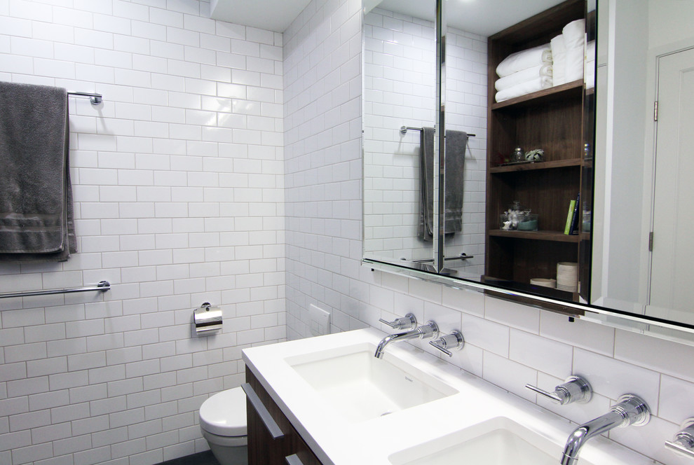 Mid-sized minimalist master white tile and ceramic tile porcelain tile tub/shower combo photo in New York with an undermount sink, dark wood cabinets, white walls, flat-panel cabinets, quartzite countertops, an undermount tub and a wall-mount toilet