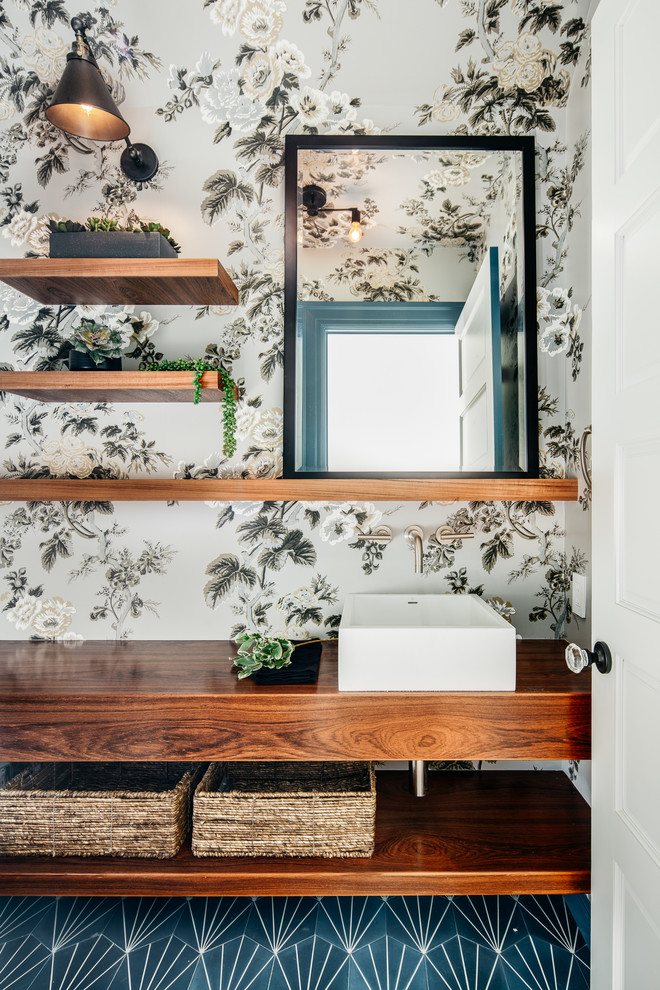 Inspiration for a small scandinavian multicolored floor bathroom remodel in San Francisco with open cabinets, medium tone wood cabinets, multicolored walls, a vessel sink and wood countertops