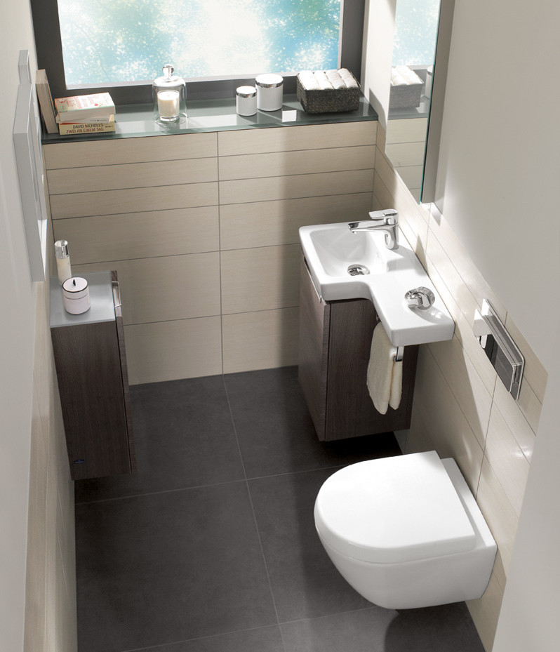 Small contemporary shower room bathroom in London with a wall mounted toilet and white walls.