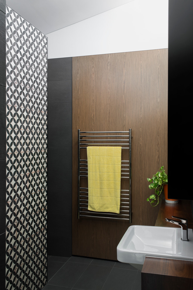 Alcove shower - mid-sized contemporary master gray tile and ceramic tile porcelain tile alcove shower idea in Sydney with an integrated sink, flat-panel cabinets, medium tone wood cabinets, wood countertops, a one-piece toilet and gray walls