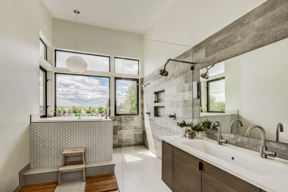 This is an example of a large contemporary ensuite bathroom in Seattle with flat-panel cabinets, a corner bath, a walk-in shower, grey tiles, wood-effect tiles, white walls, ceramic flooring, a trough sink, engineered stone worktops, white floors, an open shower, white worktops, double sinks and a floating vanity unit.