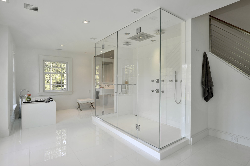 Design ideas for a modern ensuite bathroom in New York with a trough sink, white cabinets, white tiles, white walls, a freestanding bath, a double shower and ceramic flooring.