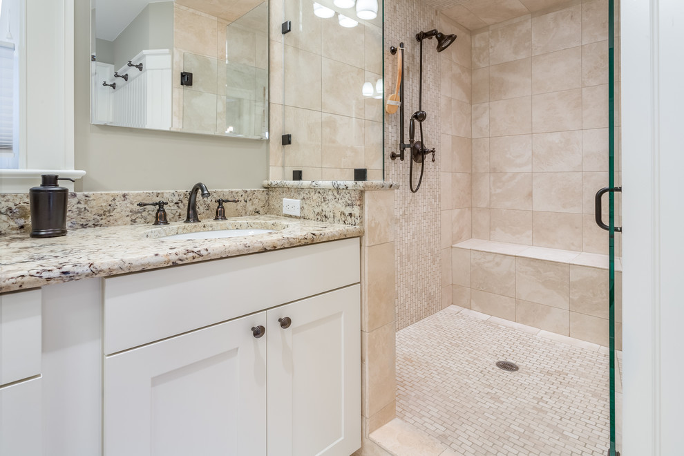 Example of a mid-sized mountain style 3/4 beige tile and stone tile travertine floor doorless shower design in Seattle with shaker cabinets, white cabinets, a wall-mount toilet, beige walls, an undermount sink and granite countertops
