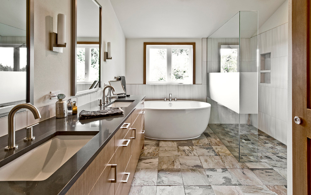 Inspiration for a mid-sized contemporary master gray tile and porcelain tile slate floor and gray floor bathroom remodel in Seattle with an undermount sink, flat-panel cabinets, medium tone wood cabinets, quartz countertops, a one-piece toilet, white walls and a hinged shower door