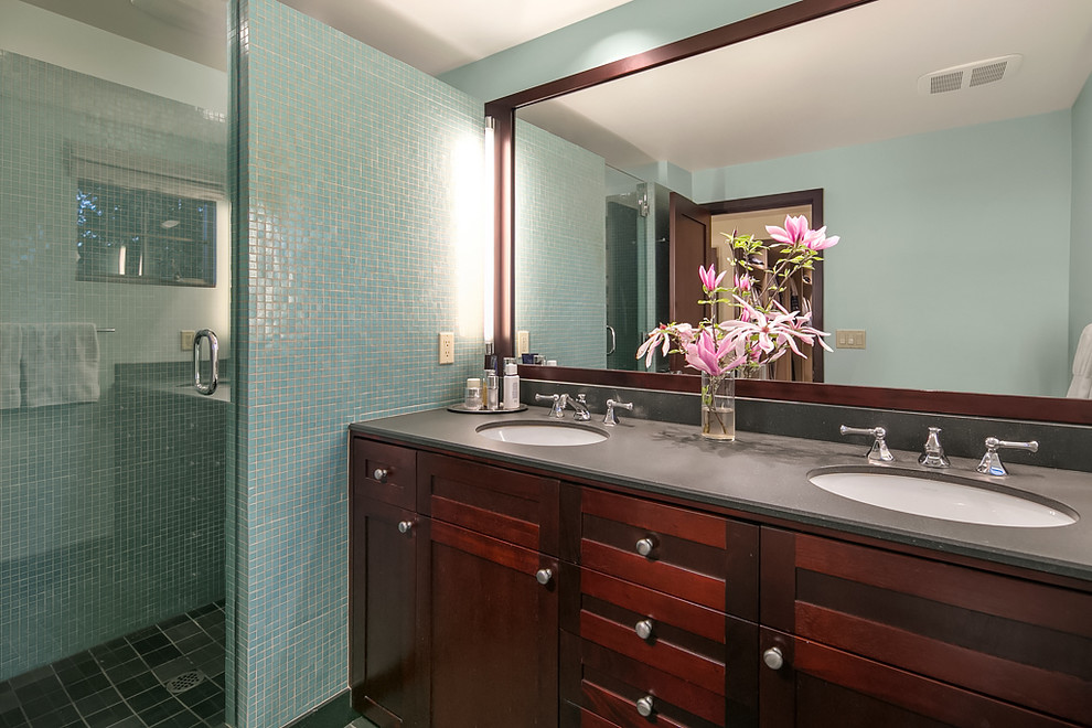 Inspiration for a small transitional master ceramic tile and blue tile black floor and ceramic tile bathroom remodel in Seattle with dark wood cabinets, a one-piece toilet, an undermount sink, granite countertops, a hinged shower door, gray countertops, shaker cabinets and blue walls