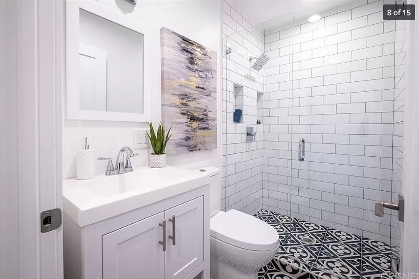 Medium sized contemporary bathroom in Los Angeles with shaker cabinets, grey cabinets, a two-piece toilet, white tiles, porcelain tiles, white walls, porcelain flooring, a console sink, tiled worktops, blue floors, a hinged door, white worktops, a wall niche, a single sink and a freestanding vanity unit.