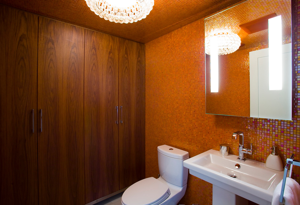 This is an example of a large contemporary shower room bathroom in Vancouver with a pedestal sink, flat-panel cabinets, medium wood cabinets, wooden worktops, a one-piece toilet, orange tiles, glass tiles, white walls and porcelain flooring.