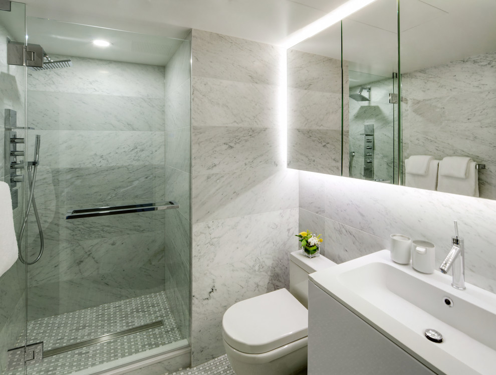Small contemporary shower room bathroom in Vancouver with an integrated sink, flat-panel cabinets, white cabinets, quartz worktops, an alcove shower, a one-piece toilet, white tiles, stone tiles, white walls and marble flooring.