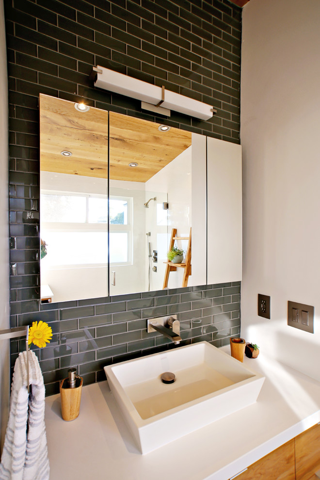 Example of a small beach style 3/4 white tile and porcelain tile porcelain tile and gray floor bathroom design in San Diego with flat-panel cabinets, light wood cabinets, a wall-mount toilet, white walls, a vessel sink, quartz countertops and white countertops
