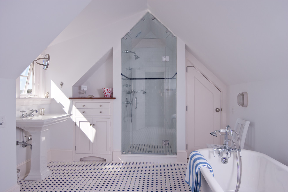 Inspiration for a nautical bathroom in Providence with a pedestal sink, shaker cabinets, white cabinets, wooden worktops, a claw-foot bath, a two-piece toilet, white tiles, ceramic tiles, white walls and porcelain flooring.