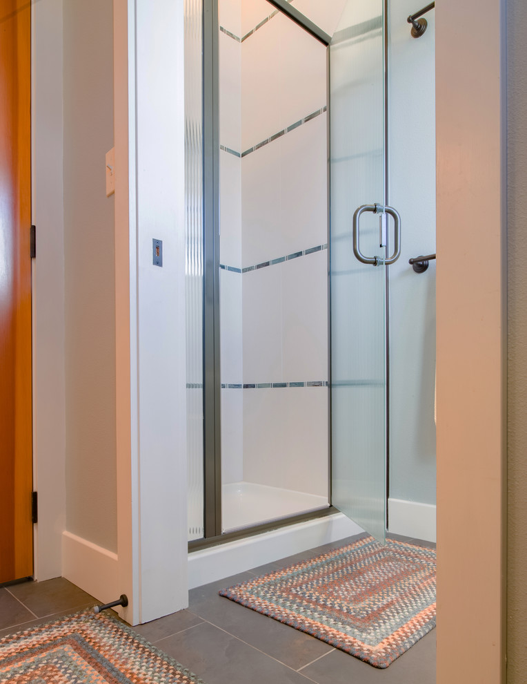 Classic family bathroom in Seattle with recessed-panel cabinets, white cabinets, an alcove shower, a two-piece toilet, blue tiles, glass sheet walls, blue walls, porcelain flooring, a trough sink and concrete worktops.