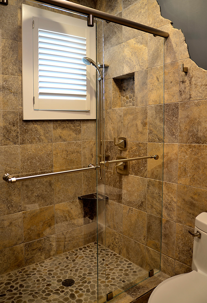 Photo of a large beach style shower room bathroom in Philadelphia with a submerged sink, shaker cabinets, black cabinets, granite worktops, a walk-in shower, brown tiles, stone tiles, blue walls and pebble tile flooring.