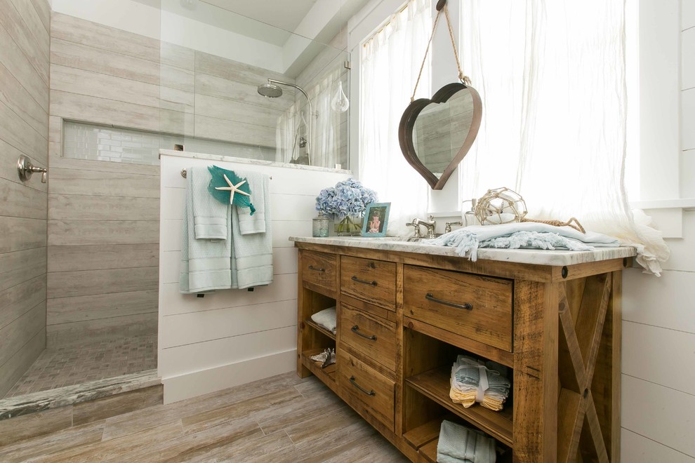 Example of a beach style 3/4 bathroom design in Charleston with medium tone wood cabinets and flat-panel cabinets