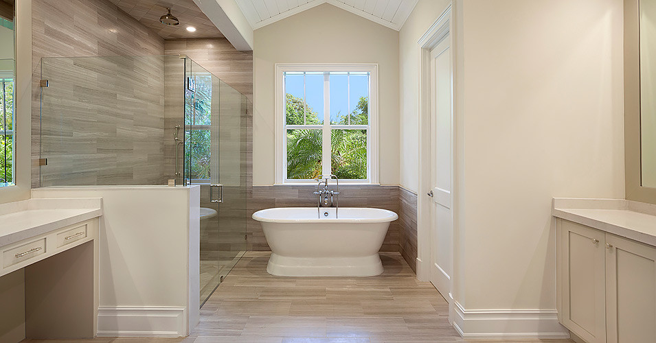 Design ideas for a large traditional ensuite bathroom in Miami with beige cabinets, a freestanding bath, a walk-in shower, beige walls and porcelain flooring.