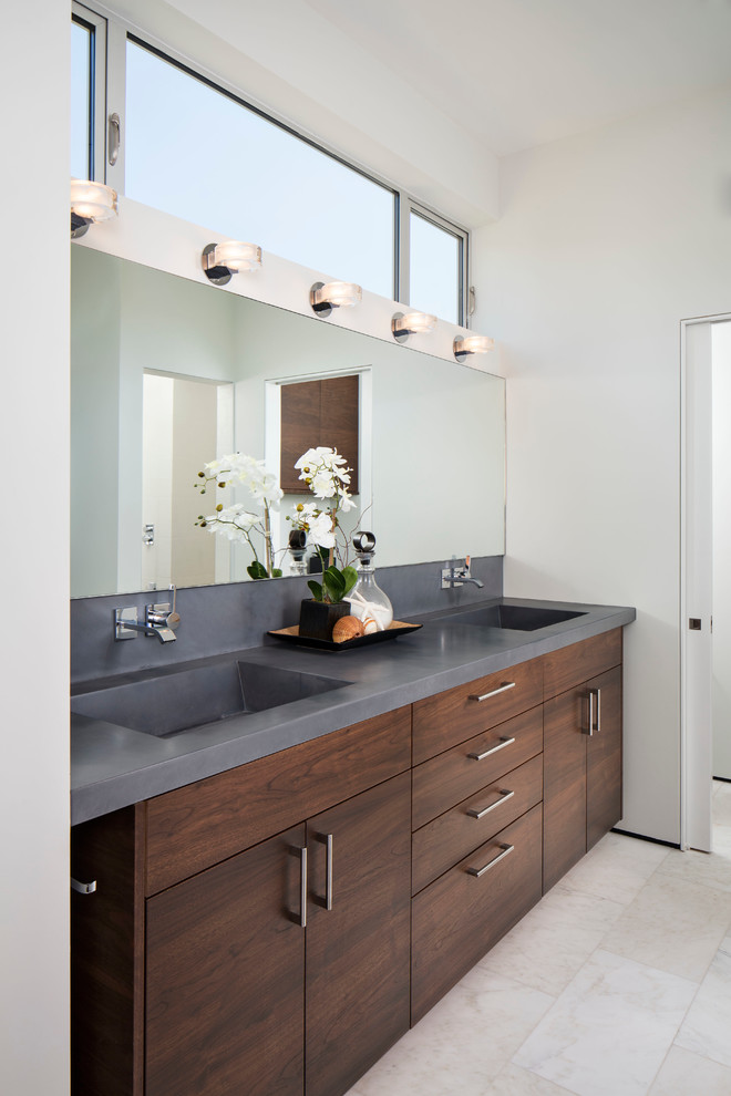 Design ideas for a large coastal ensuite bathroom in San Diego with an integrated sink, flat-panel cabinets, dark wood cabinets, white walls, ceramic flooring, solid surface worktops and grey worktops.