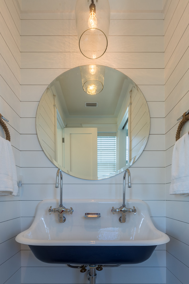 Inspiration for a small transitional 3/4 bathroom remodel in Jacksonville with a two-piece toilet, white walls and a wall-mount sink