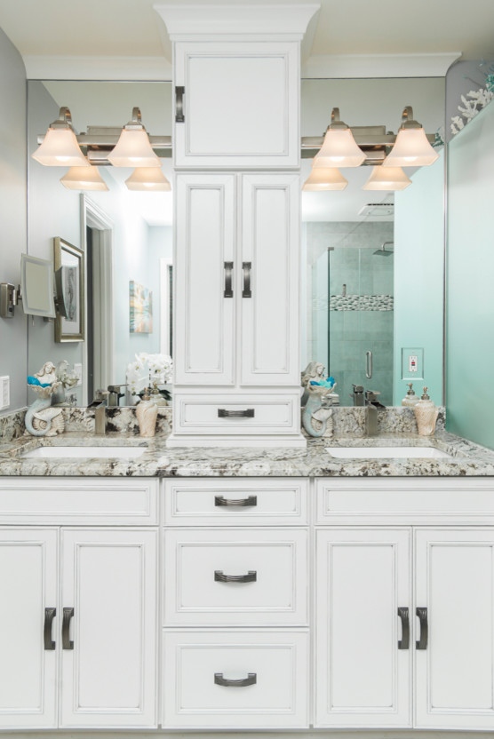 Example of a small beach style master porcelain tile and gray floor drop-in bathtub design in Atlanta with recessed-panel cabinets, blue walls, an undermount sink and granite countertops