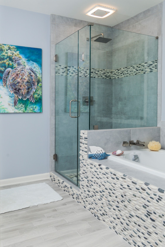 Small beach style master porcelain tile and gray floor drop-in bathtub photo in Atlanta with recessed-panel cabinets, blue walls, an undermount sink and granite countertops