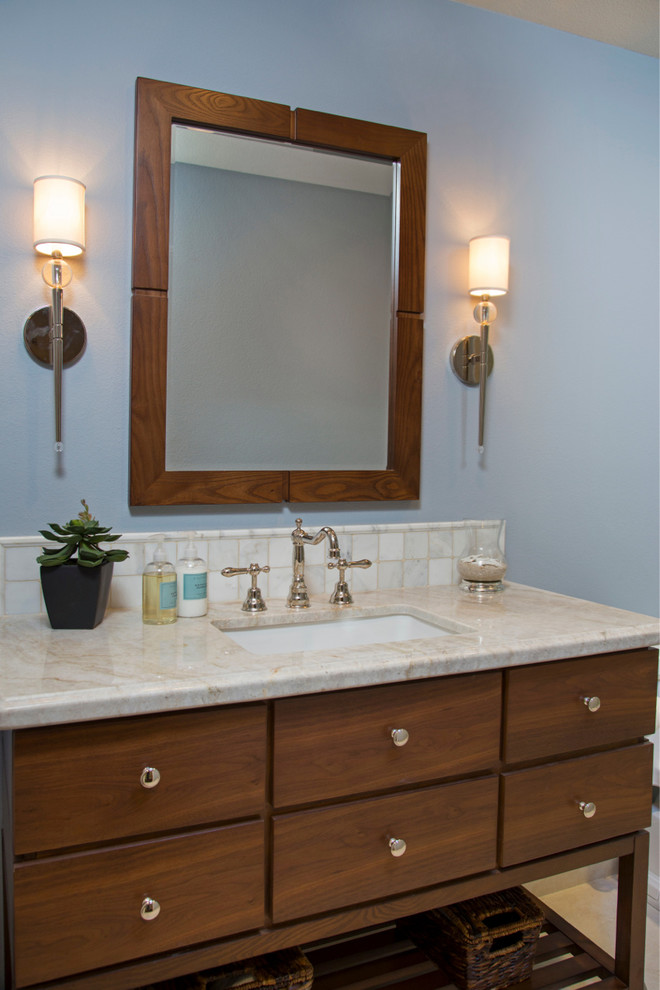 This is an example of a medium sized classic shower room bathroom in San Diego with flat-panel cabinets, medium wood cabinets, an alcove shower, a one-piece toilet, beige tiles, blue walls, a built-in sink, ceramic tiles, quartz worktops and limestone flooring.