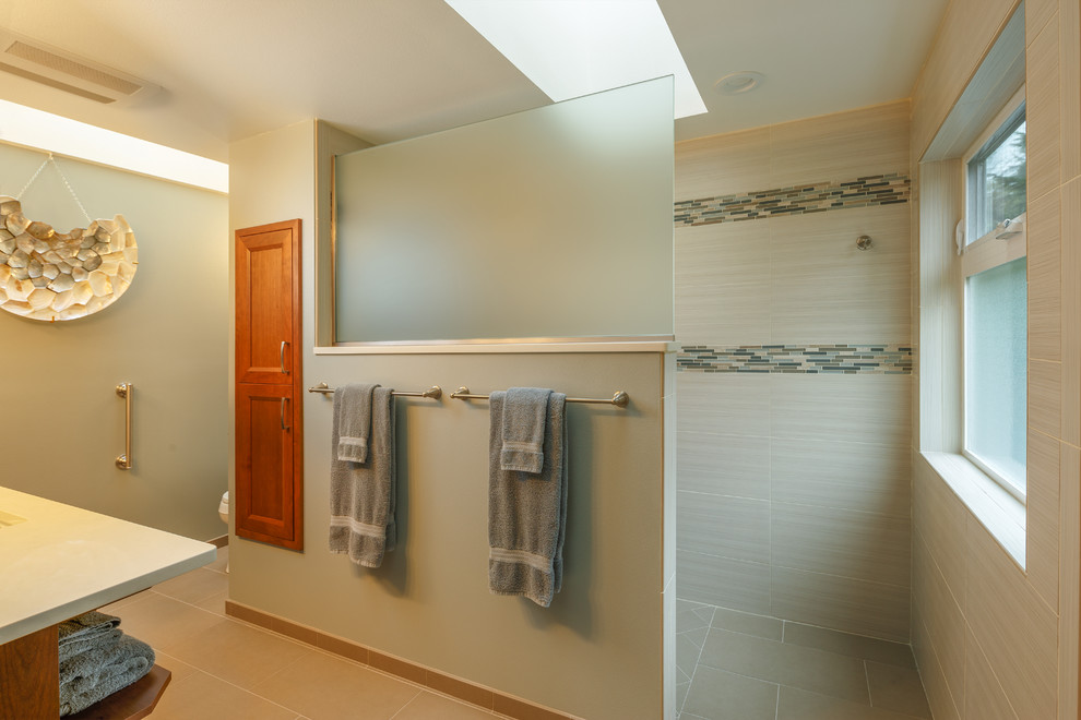 Inspiration for a mid-sized coastal master multicolored tile and matchstick tile porcelain tile doorless shower remodel in Seattle with recessed-panel cabinets, medium tone wood cabinets, green walls, an undermount sink and quartz countertops