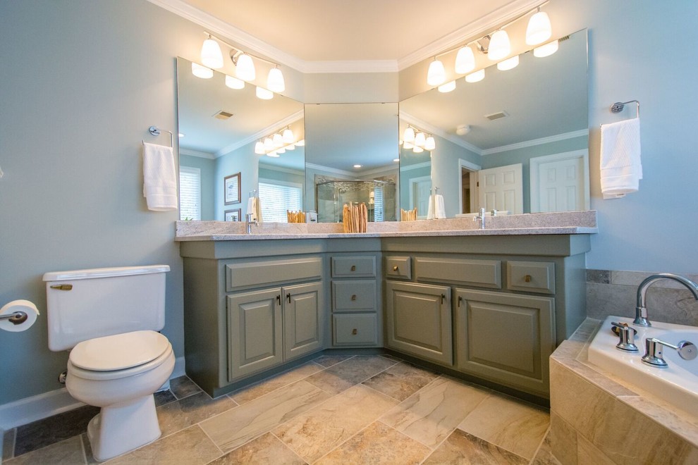 Large traditional ensuite bathroom in Raleigh with raised-panel cabinets, green cabinets, a built-in bath, a corner shower, a two-piece toilet, multi-coloured tiles, stone slabs, green walls, slate flooring, a submerged sink and laminate worktops.