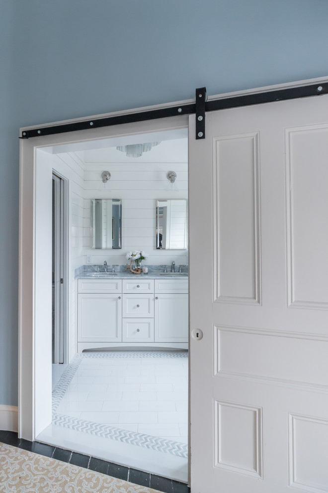This is an example of a medium sized traditional ensuite bathroom in Boston with beaded cabinets, white cabinets, an alcove shower, a two-piece toilet, white tiles, porcelain tiles, white walls, porcelain flooring, a submerged sink, quartz worktops, white floors, a hinged door and blue worktops.