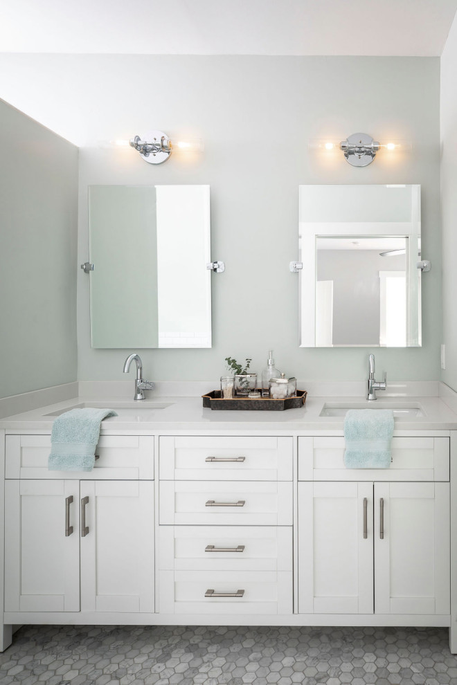 Photo of a medium sized coastal ensuite bathroom in Orlando with shaker cabinets, white cabinets, a freestanding bath, an alcove shower, a two-piece toilet, white tiles, ceramic tiles, green walls, marble flooring, a submerged sink, marble worktops, grey floors, a hinged door and white worktops.