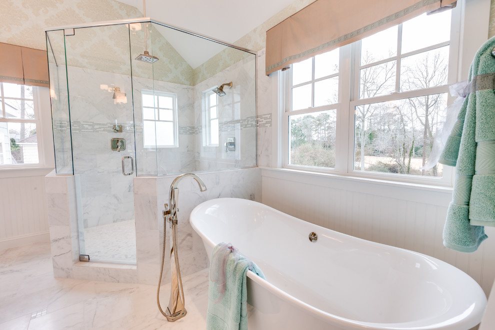 This is an example of a large ensuite bathroom in Other with a submerged sink, recessed-panel cabinets, white cabinets, marble worktops, a freestanding bath, a corner shower, a two-piece toilet, white tiles, stone tiles, grey walls and marble flooring.
