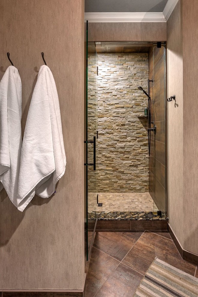 Inspiration for a medium sized classic ensuite bathroom in Detroit with recessed-panel cabinets, dark wood cabinets, an alcove shower, beige tiles, brown tiles, grey tiles, stone tiles, beige walls, ceramic flooring, a submerged sink, granite worktops, brown floors and a hinged door.