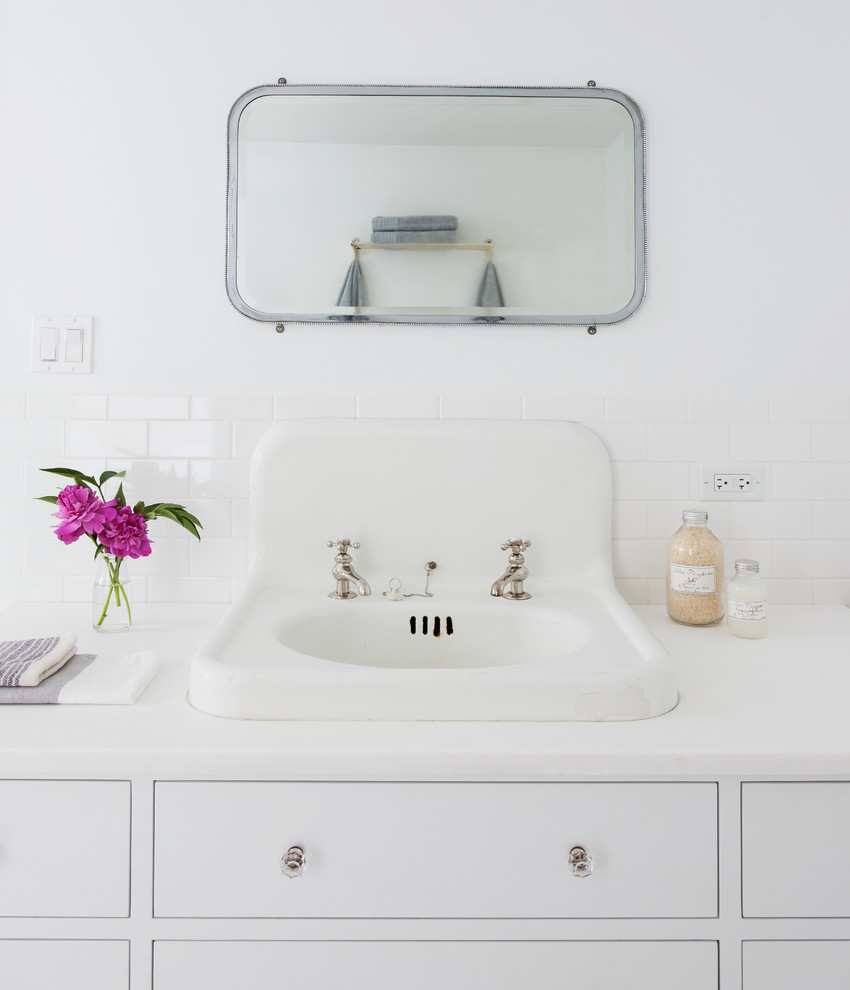 Example of a large trendy master white tile and ceramic tile ceramic tile claw-foot bathtub design in New York with a drop-in sink, furniture-like cabinets, white cabinets, marble countertops and white walls