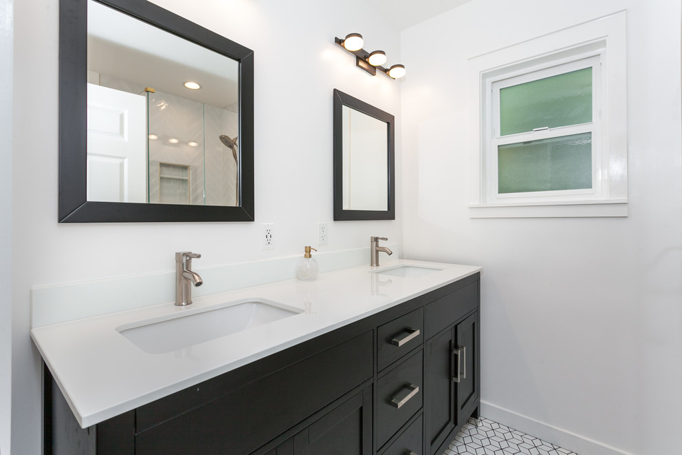 Corner shower - mid-sized modern 3/4 white tile and subway tile porcelain tile and white floor corner shower idea in Los Angeles with beaded inset cabinets, dark wood cabinets, a one-piece toilet, white walls, a drop-in sink, quartz countertops, a hinged shower door and white countertops