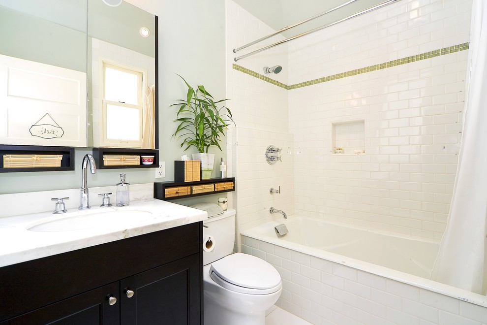 Elegant subway tile bathroom photo in San Francisco with black cabinets