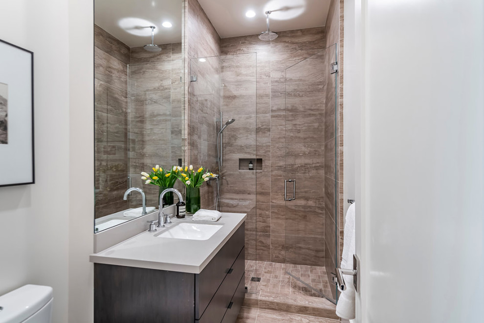 Example of a mid-sized minimalist 3/4 gray tile and wood-look tile wood-look tile floor, gray floor and single-sink alcove shower design in San Francisco with flat-panel cabinets, brown cabinets, a one-piece toilet, gray walls, an undermount sink, quartz countertops, a hinged shower door, gray countertops and a freestanding vanity