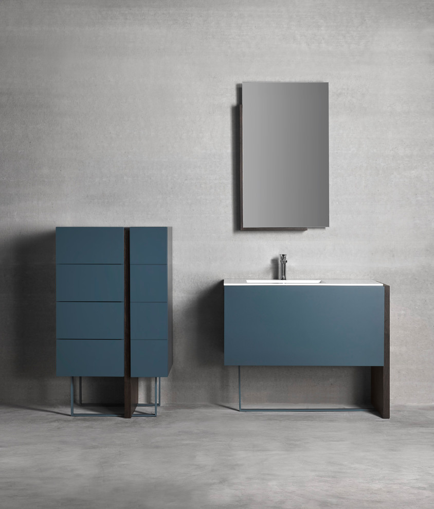 Immagine di una stanza da bagno con doccia contemporanea di medie dimensioni con ante lisce, ante blu, piastrelle grigie, lavabo integrato, top in superficie solida e top bianco